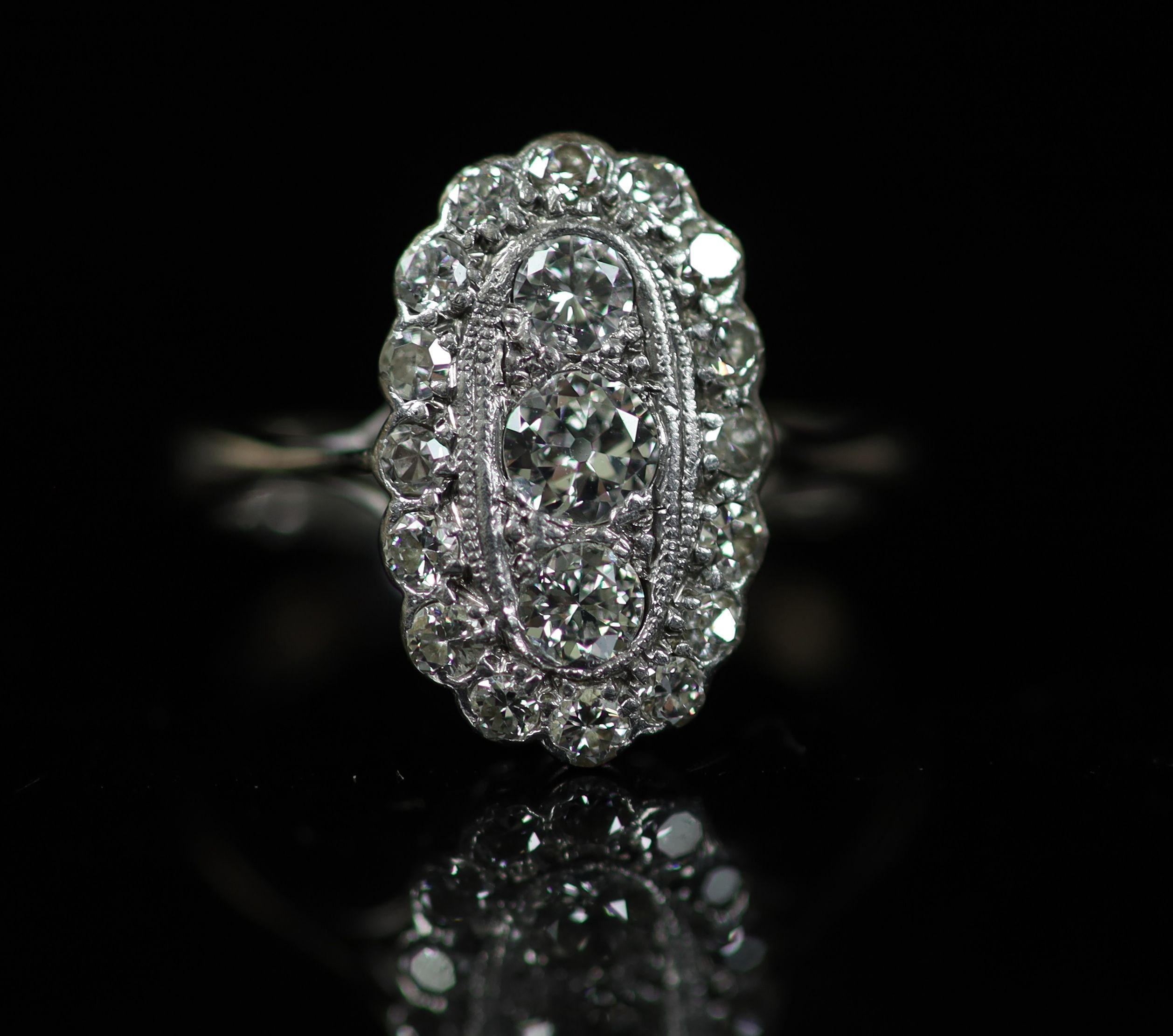 A 1940's 18ct white gold and diamond set oval cluster ring